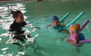 Swimming School Instructor and Two Kids Aqua Dynamics